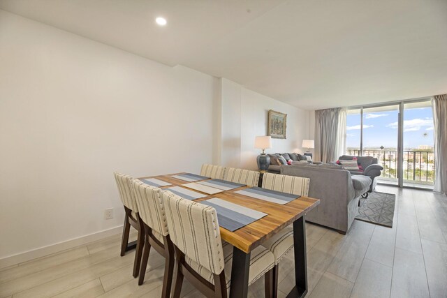 dining space with light hardwood / wood-style floors and sink