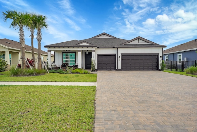 view of front of property featuring a front yard and a garage