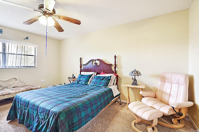 carpeted bedroom with a textured ceiling and ceiling fan