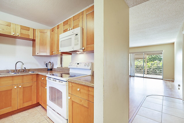 kitchen with sink, a textured ceiling, and white appliances