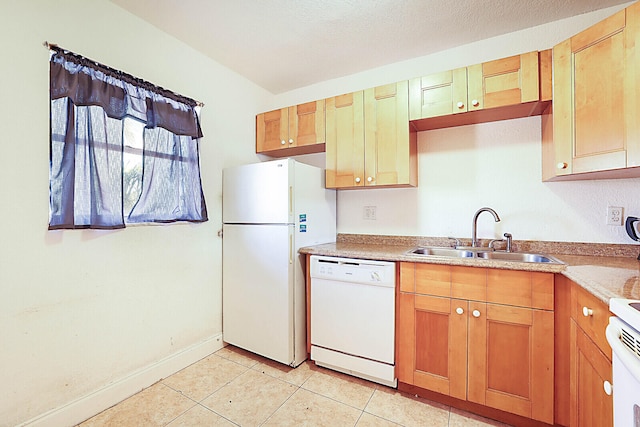 kitchen featuring sink, light tile patterned flooring, a textured ceiling, and white appliances