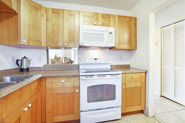 kitchen featuring white appliances and light tile patterned floors