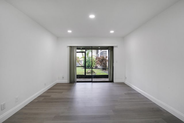 spare room featuring dark hardwood / wood-style flooring