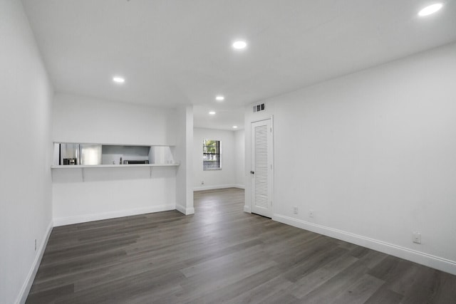 unfurnished living room featuring dark hardwood / wood-style flooring