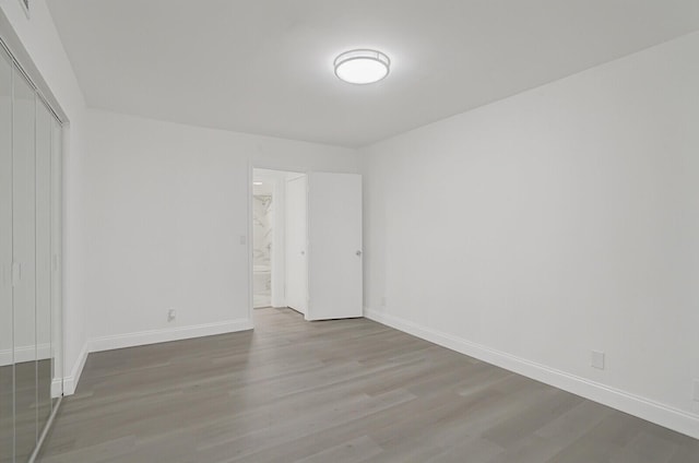 empty room with hardwood / wood-style flooring