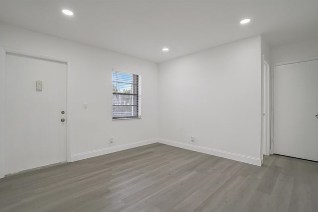 empty room with light hardwood / wood-style flooring