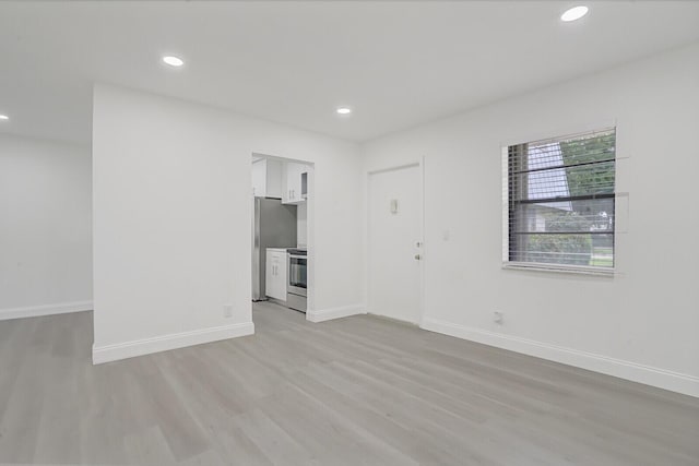 spare room featuring light hardwood / wood-style flooring