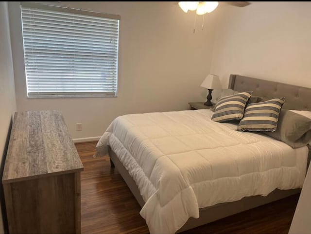 bedroom featuring ceiling fan and dark hardwood / wood-style flooring