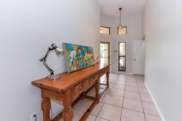 foyer entrance with light tile patterned floors and a high ceiling