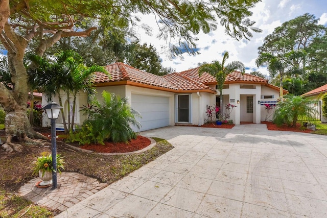 mediterranean / spanish home with a garage