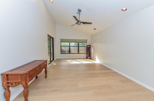 hall featuring light hardwood / wood-style floors and high vaulted ceiling