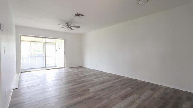 empty room with ceiling fan and dark hardwood / wood-style flooring