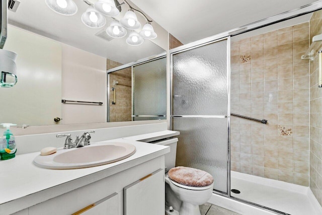 bathroom with toilet, a shower with shower door, vanity, and tile patterned flooring