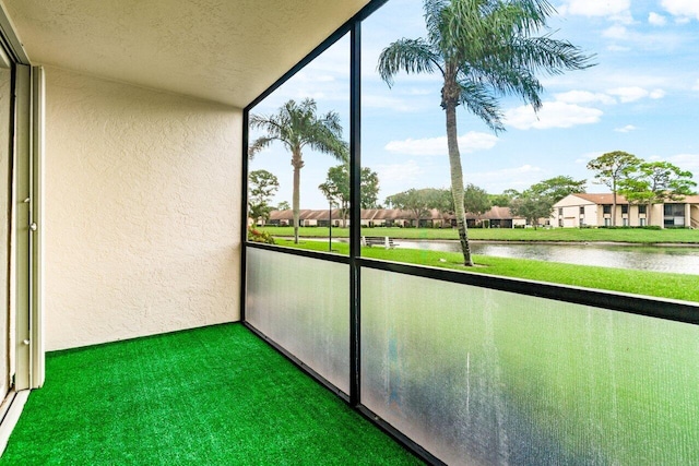 unfurnished sunroom with a water view