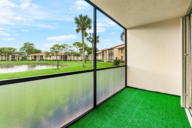 unfurnished sunroom with a water view