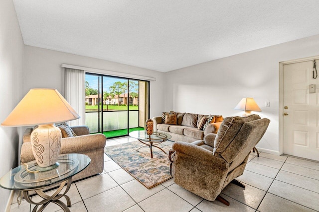 tiled living room featuring a textured ceiling