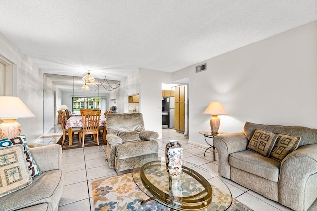 living room with a textured ceiling and light tile patterned floors