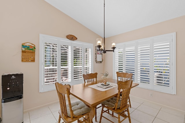 dining area featuring lofted ceiling, a notable chandelier, and light tile patterned floors