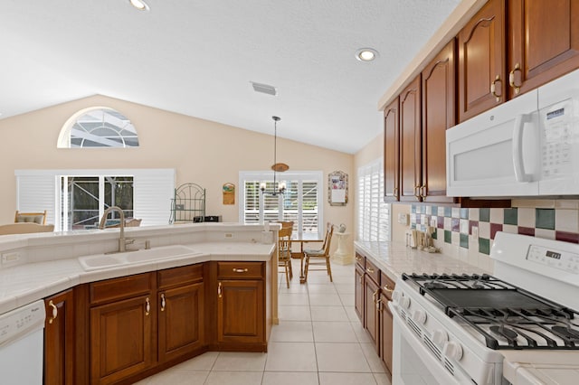 kitchen featuring white appliances, light tile patterned flooring, sink, lofted ceiling, and decorative backsplash