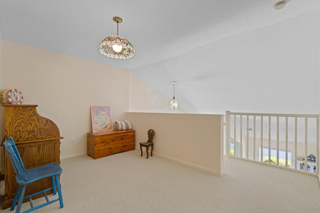 sitting room featuring carpet and vaulted ceiling