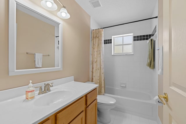 full bathroom with a textured ceiling, toilet, shower / bath combo with shower curtain, vanity, and tile patterned flooring