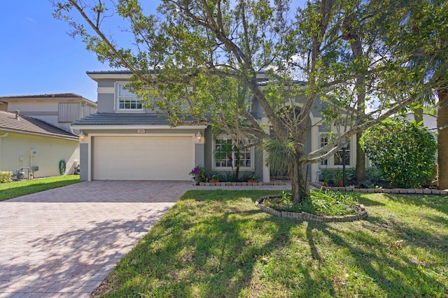 view of front of home featuring a front yard and a garage