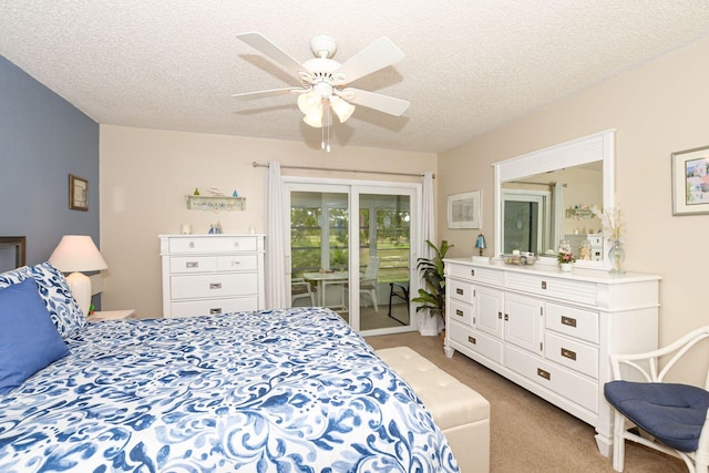 carpeted bedroom with access to outside, a textured ceiling, and ceiling fan