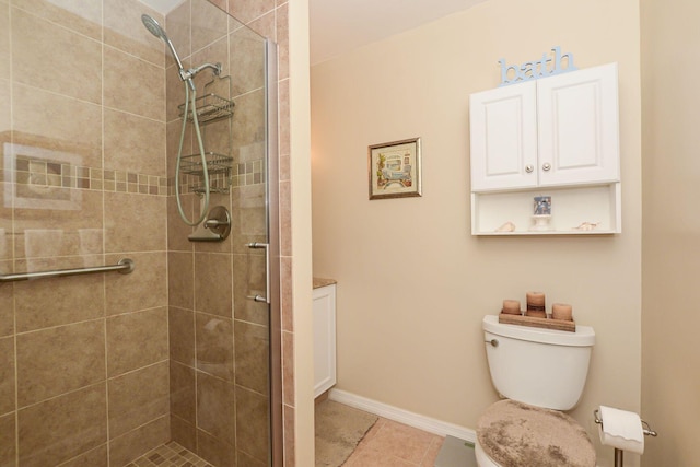 bathroom featuring toilet, an enclosed shower, and tile patterned flooring