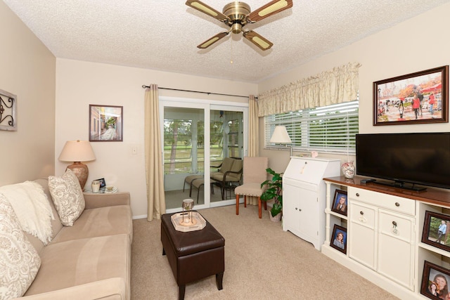 living room featuring plenty of natural light, light carpet, and ceiling fan