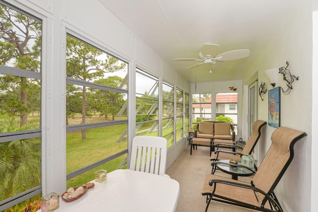 sunroom / solarium with a healthy amount of sunlight and ceiling fan