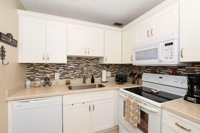 kitchen with white cabinets, a textured ceiling, sink, and white appliances