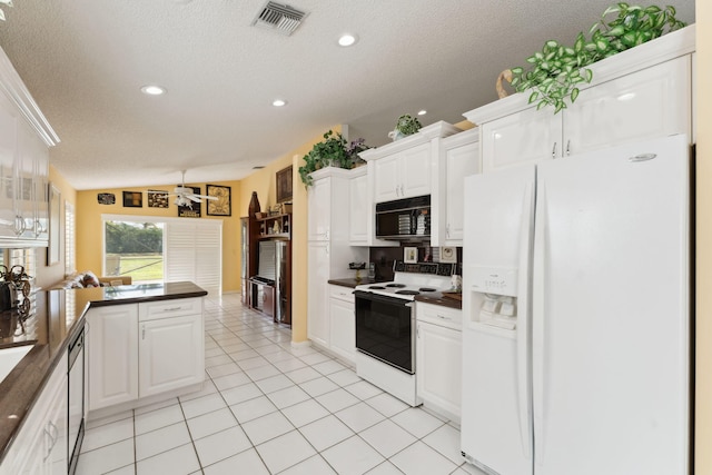 kitchen with vaulted ceiling, white cabinetry, a textured ceiling, and white appliances