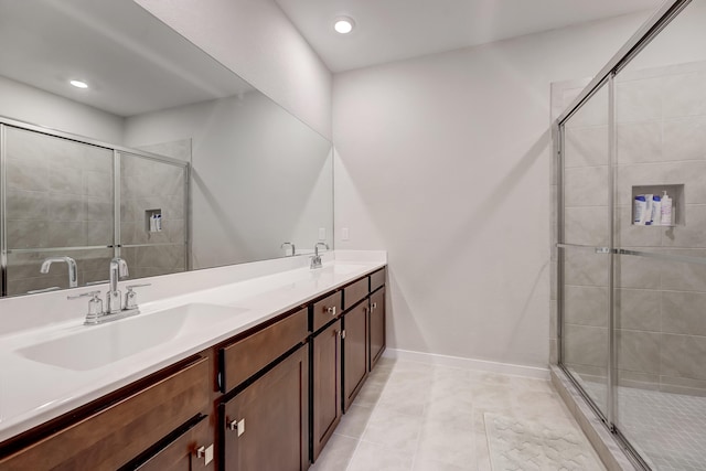 bathroom with vanity and a shower with door