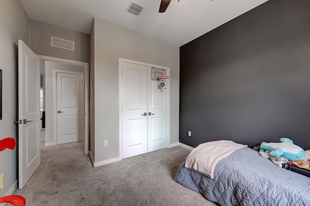 carpeted bedroom with a closet and ceiling fan