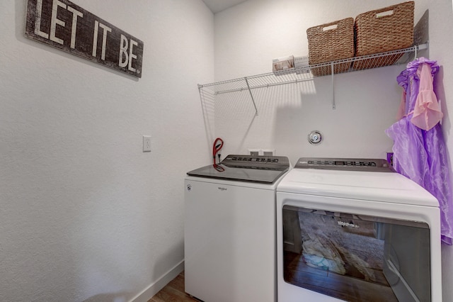 washroom with hardwood / wood-style floors and washer and dryer