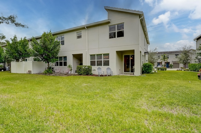 back of property with a lawn