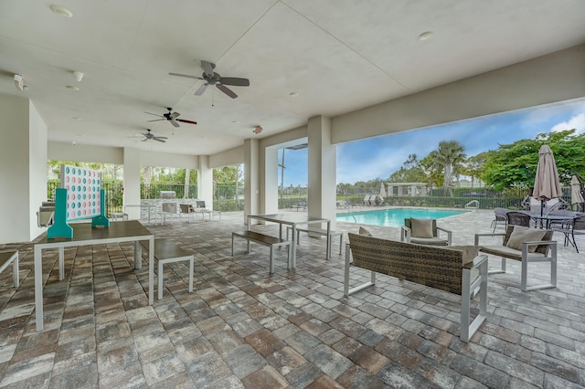 view of patio / terrace featuring a fenced in pool and ceiling fan