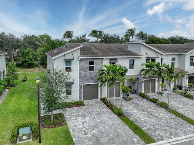 view of front of house with a garage and a front yard