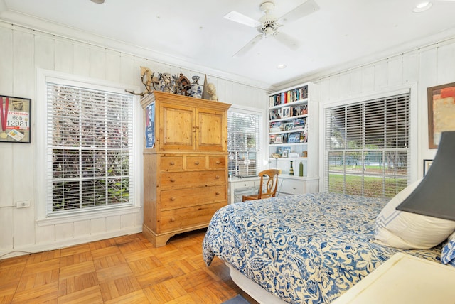5400 Essex Ct, West Palm Beach, FL 33405 - bedroom featuring ornamental molding, light parquet floors, ceiling fan, and wooden walls