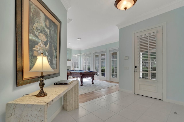 rec room with french doors, light tile patterned floors, ornamental molding, and billiards