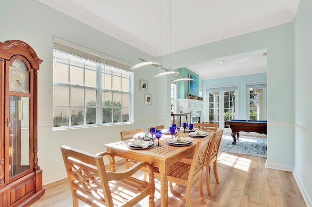 dining space featuring ornamental molding, billiards, and light wood-type flooring