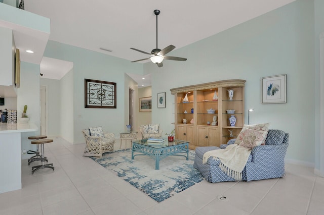 living room featuring vaulted ceiling, light tile patterned flooring, and ceiling fan