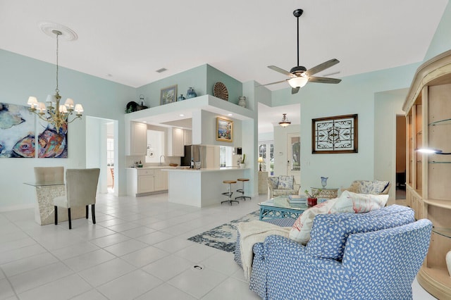 living room featuring sink, light tile patterned floors, a wealth of natural light, and ceiling fan with notable chandelier