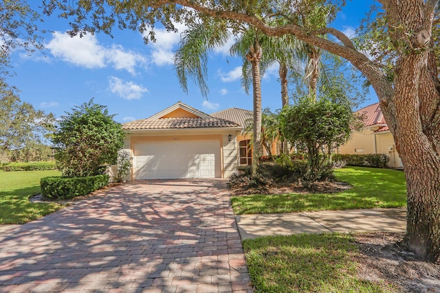 mediterranean / spanish-style home with a front yard and a garage