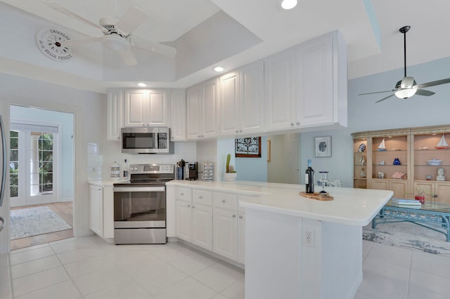 kitchen featuring white cabinetry, kitchen peninsula, and stainless steel appliances