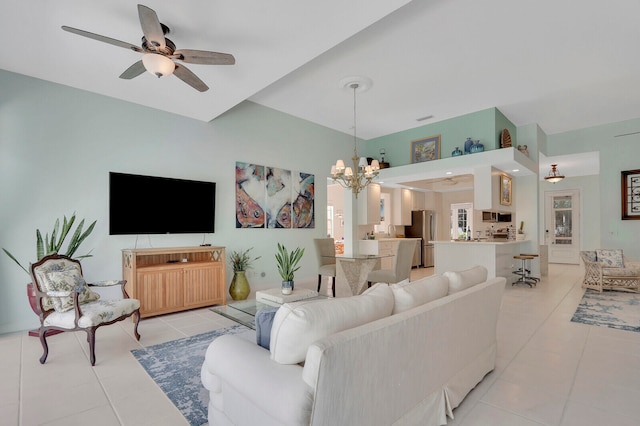 living room with ceiling fan with notable chandelier and light tile patterned floors