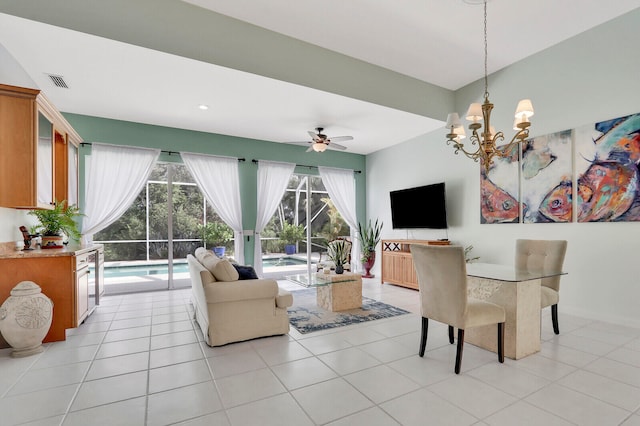 dining area with ceiling fan with notable chandelier and light tile patterned floors