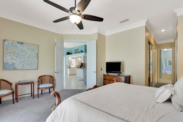 carpeted bedroom with ceiling fan, crown molding, and ensuite bathroom