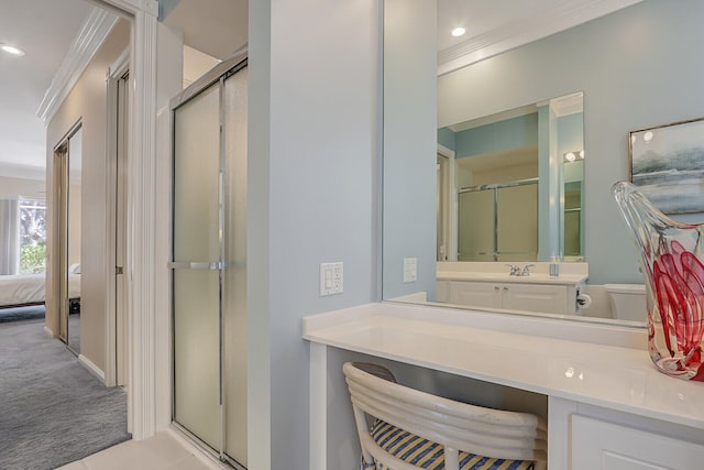 bathroom featuring vanity, ornamental molding, and walk in shower