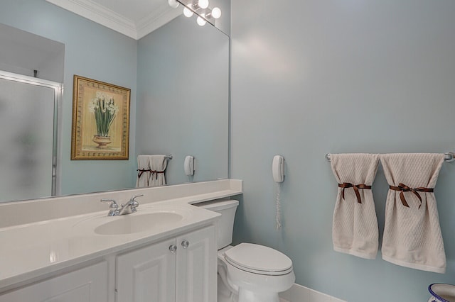 bathroom with a shower with door, vanity, ornamental molding, and toilet